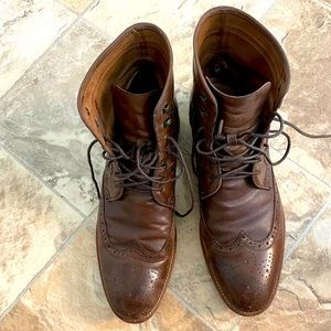 A pair of used, brown, Johnston and Murphy wingtip boots.